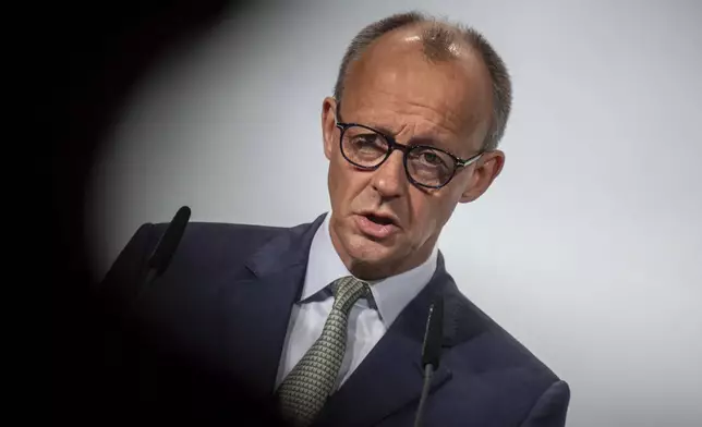German Chancellor Friedrich Merz speaks at the municipal congress of the German Association of Towns and Municipalities (DStGB) in Berlin, Germany, Tuesday June 3, 2025. (Michael Kappeler/dpa via AP)