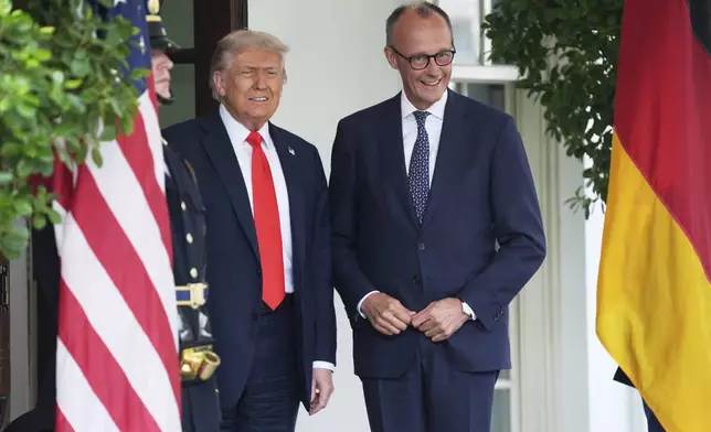 President Donald Trump, left, greets Germany's Chancellor Friedrich Merz at the White House, Thursday, June 5, 2025, in Washington. (AP Photo/Evan Vucci)