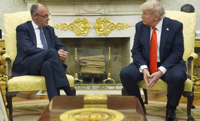 President Donald Trump, right, listens during a meeting with Germany's Chancellor Friedrich Merz in the Oval Office of the White House, Thursday, June 5, 2025, in Washington. (AP Photo/Evan Vucci)