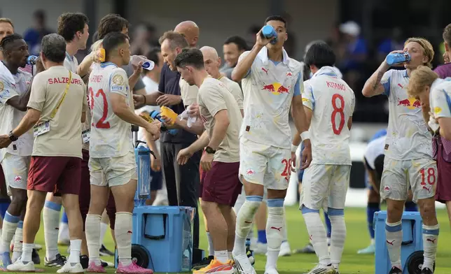 Red Bull Salzburg players take a drinks break during the Club World Cup Group H soccer match between Salzburg and Al Hilal in Washington, Sunday, June 22, 2025. (AP Photo/Julia Demaree Nikhinson)
