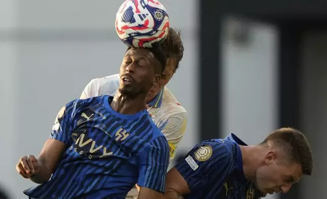 Al-Hilal's Mohamed Kanno, front, makes a header ahead of Red Bull Salzburg's John Mellberg during the Club World Cup Group H soccer match between Salzburg and Al Hilal in Washington, Sunday, June 22, 2025. (AP Photo/Julia Demaree Nikhinson)