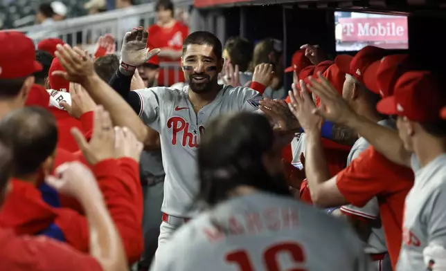 Philadelphia Phillies' Nick Castellanos celebrates with teammates after hitting a home run during the second inning of a baseball game against the Atlanta Braves, Friday, June 27, 2025, in Atlanta. (AP Photo/Butch Dill)
