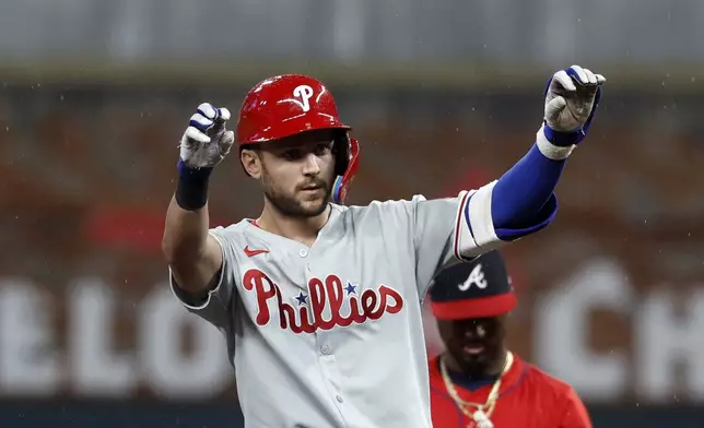 Philadelphia Phillies' Trea Turner reacts after hitting a double during the first inning of a baseball game against the Atlanta Braves, Friday, June 27, 2025, in Atlanta. (AP Photo/Butch Dill)