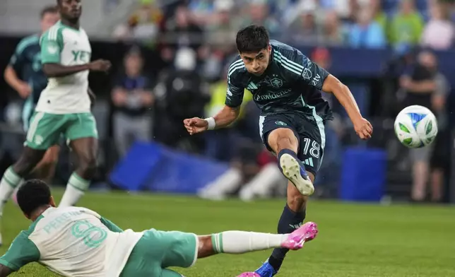 Seattle Sounders midfielder Obed Vargas (18) makes a shot on goal as Austin FC midfielder Daniel Pereira (8) defends during the second half of an MLS soccer match Saturday, June 28, 2025, in Seattle. (AP Photo/Lindsey Wasson)