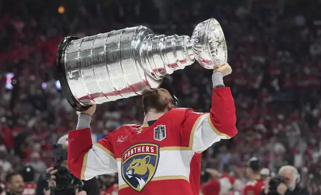 Florida Panthers center Sam Reinhart (13) kisses the Stanley Cup after defeating the Edmonton Oilers in Game 6 of the NHL hockey Stanley Cup Final Tuesday, June 17, 2025, in Sunrise, Fla. (AP Photo/Lynne Sladky)
