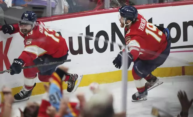 Florida Panthers' Sam Reinhart (13) celebrates after his goal against the Edmonton Oilers with teammate Matthew Tkachuk (19) during the third period in Game 4 of the NHL hockey Stanley Cup Final in Sunrise, Fla., Thursday, June 12, 2025. (Nathan Denette/The Canadian Press via AP)
