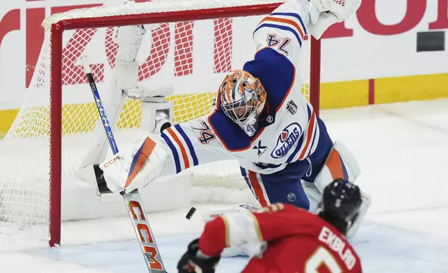 Florida Panthers' Aaron Ekblad (5) scores on Edmonton Oilers goalie Stuart Skinner (74) during the third period in Game 3 of the NHL hockey Stanley Cup finals in Sunrise, Fla., Monday, June 9, 2025. (Nathan Denette/The Canadian Press via AP)