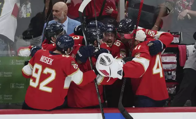 Florida Panthers players celebrate an empty net goal against the Edmonton Oilers during the third period in Game 6 of the NHL hockey Stanley Cup Final in Sunrise, Fla., Tuesday, June 17, 2025. (Nathan Denette/The Canadian Press via AP)