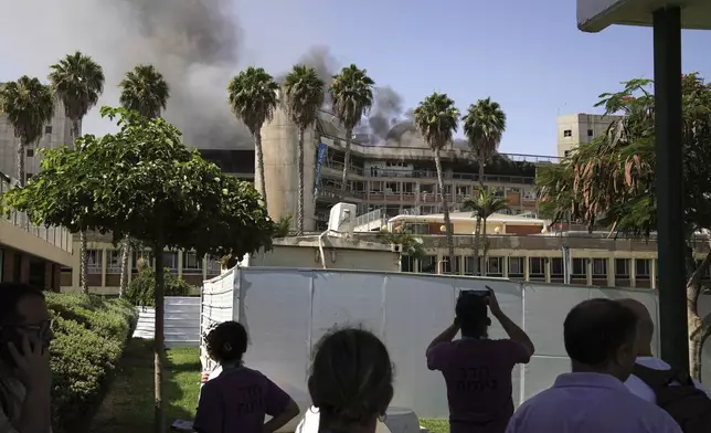 Smokes rises from a building of the Soroka hospital complex after it was hit by a missile fired from Iran in Beersheba, Israel, Thursday, June 19, 2025. (AP Photo/Leo Correa)