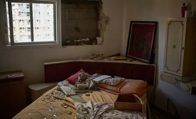 Debris is scattered over a bed inside a damaged apartment a day after of an Iranian missile strike in Ramat Gan, Israel, Friday, June 20, 2025. (AP Photo/Leo Correa)