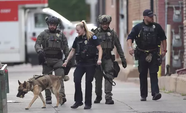 Law enforcement officials investigate after an attack on the Pearl Street Mall Sunday, June 1, 2025, in Boulder, Colo. (AP Photo/David Zalubowski)