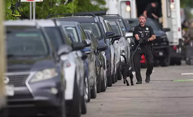 Law enforcement officials investigate after an attack on the Pearl Street Mall Sunday, June 1, 2025, in Boulder, Colo. (AP Photo/David Zalubowski)