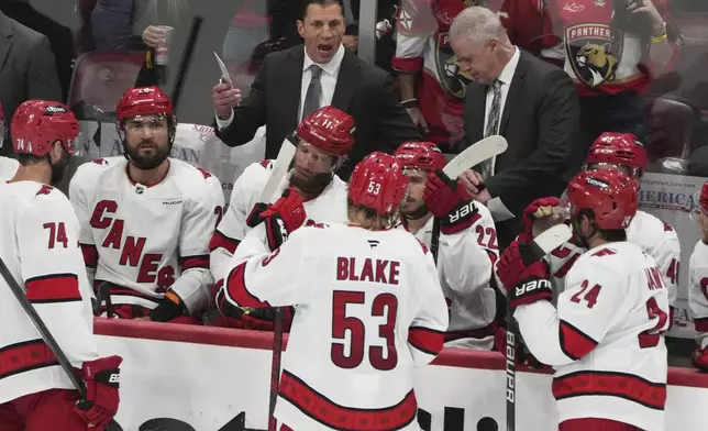 Florida Panthers head coach Rod Brind'Amour, left, rear, talks with his players during the third period against the Florida Panthers in Game 3 of the NHL hockey Stanley Cup Eastern Conference finals Saturday, May 24, 2025, in Sunrise, Fla. (AP Photo/Lynne Sladky)
