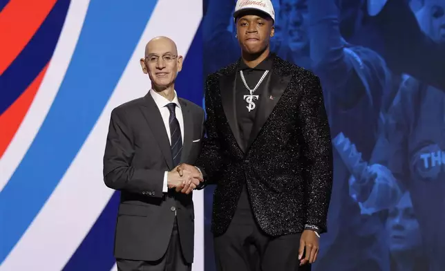 Thomas Sorber poses for a photo with NBA commissioner Adam Silver after being selected 15th by the Oklahoma City Thunder in the first round of the NBA basketball draft, Wednesday, June 25, 2025, in New York. (AP Photo/Adam Hunger)
