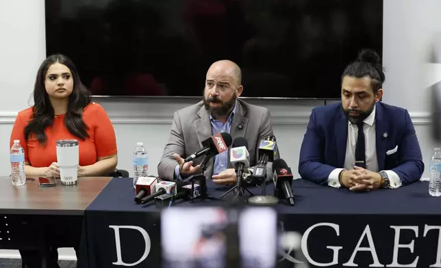 Giovanni Diaz, center, alongside Zacharias Gaeta and Katherine Guevara, speaks during a press conference about the status of Mario Guevara, a metro Atlanta-based Spanish-language reporter from MGNews, addressing his situation following his arrest while covering an immigration rally, Tuesday, June 17, 2025, in Smyrna, Ga. (Miguel Martinez/Atlanta Journal-Constitution via AP)