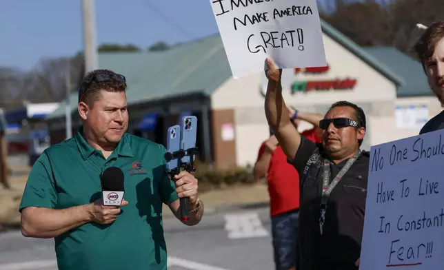 Mario Guevara, the metro Atlanta-based Spanish-language reporter, covers a protest against immigration enforcement on Buford Highway, Ga., on Saturday, Feb. 1, 2025. (Miguel Martinez/Atlanta Journal-Constitution via AP)