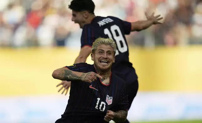 United States midfielder Diego Angel Luna (10) celebrates next to midfielder Maximilian Michael Arfsten (18) after scoring during the first half of a CONCACAF Gold Cup quarterfinals soccer match against Costa Rica, Sunday, June 29, 2025, in Minneapolis. (AP Photo/Abbie Parr)