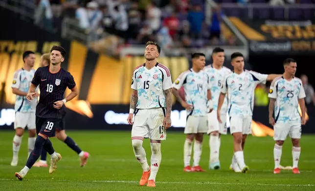 Costa Rica defender Francisco Javier Calvo Quesada (15) stands on the field with teammates after losing to the United states in penalty kicks of a CONCACAF Gold Cup quarterfinals soccer match, Sunday, June 29, 2025, in Minneapolis. (AP Photo/Abbie Parr)