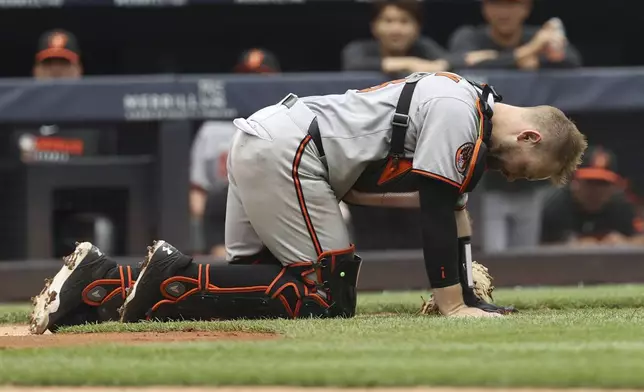 Baltimore Orioles catcher Maverick Handley reacts after colliding with New York Yankees' Jazz Chisholm Jr. during the second inning of a baseball game Sunday, June 22, 2025, in New York. (AP Photo/Pamela Smith)
