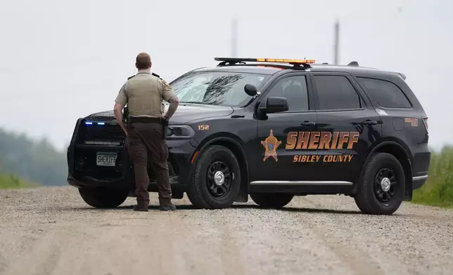 A Sibley County Sheriff's Deputy blocks the road where the suspect involved in the shooting of two state lawmakers vehicle was found Sunday, June 15, 2025, in Faxon Township, Minn. (AP Photo/George Walker IV)