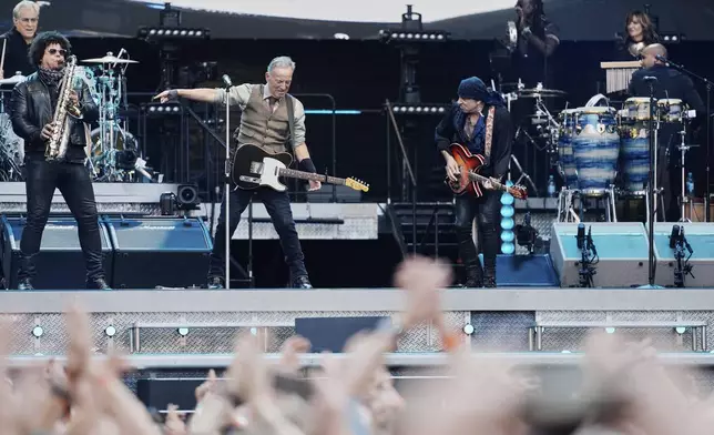 Bruce Springsteen, center, performs with the E Street Band at the Olympic Stadium in Berlin, Germany, Wednesday, June 11, 2025. (AP Photo/Markus Schreiber)