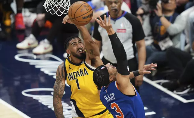 Indiana Pacers forward Obi Toppin (1) blocks a shot by New York Knicks guard Josh Hart (3) during the first half of Game 6 of the Eastern Conference finals of the NBA basketball playoffs in Indianapolis, Saturday, May 31, 2025. (AP Photo/AJ Mast)