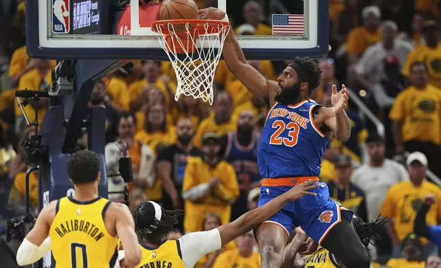 New York Knicks center Mitchell Robinson (23) dunks during the first half of Game 6 of the Eastern Conference finals of the NBA basketball playoffs against the Indiana Pacers in Indianapolis, Saturday, May 31, 2025. (AP Photo/Michael Conroy)
