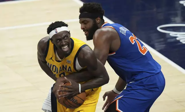 New York Knicks center Mitchell Robinson (23) defends against Indiana Pacers forward Pascal Siakam, left, during the second half of Game 6 of the Eastern Conference finals of the NBA basketball playoffs in Indianapolis, Saturday, May 31, 2025. (AP Photo/AJ Mast)