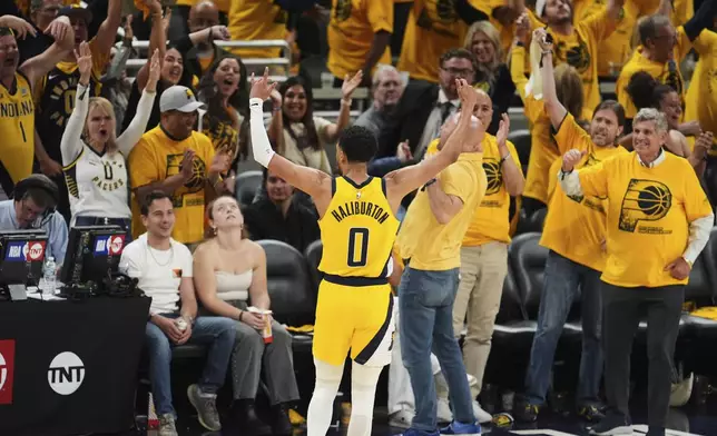 Indiana Pacers guard Tyrese Haliburton celebrates after a teammate made a 3-pointer during the second half of Game 6 of the Eastern Conference finals of the NBA basketball playoffs against the New York Knicks in Indianapolis, Saturday, May 31, 2025. (AP Photo/Michael Conroy)