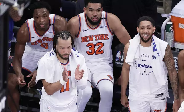 New York Knicks guard Jalen Brunson (11), forward OG Anunoby (8), center Karl-Anthony Towns (32) and guard Cameron Payne (1) react during the fourth quarter of Game 5 of the NBA basketball Eastern Conference finals against the Indiana Pacers, Thursday, May 29, 2025, in New York. (AP Photo/Adam Hunger)