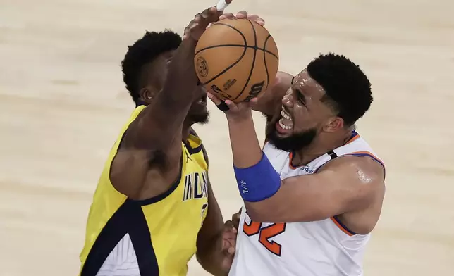 New York Knicks center Karl-Anthony Towns (32) puts up a shot against Indiana Pacers center Thomas Bryant (3) during the third quarter of Game 5 of the NBA basketball Eastern Conference finals, Thursday, May 29, 2025, in New York. (AP Photo/Adam Hunger)