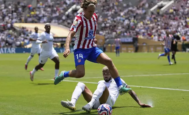 Atletico Madrid's Marcos Llorente jumps over Botafogo's Alexander Barboza during the Club World Cup Group B soccer match between Atletico Madrid and Botafogo in Pasadena, Calif., Monday, June 23, 2025. (AP Photo/Gregory Bull)