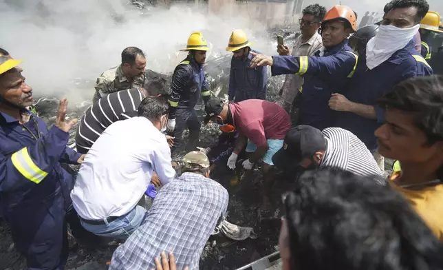 Rescuers work at the site of an airplane that crashed in India's northwestern city of Ahmedabad in Gujarat state, Thursday, June 12, 2025. (AP Photo/Ajit Solanki)