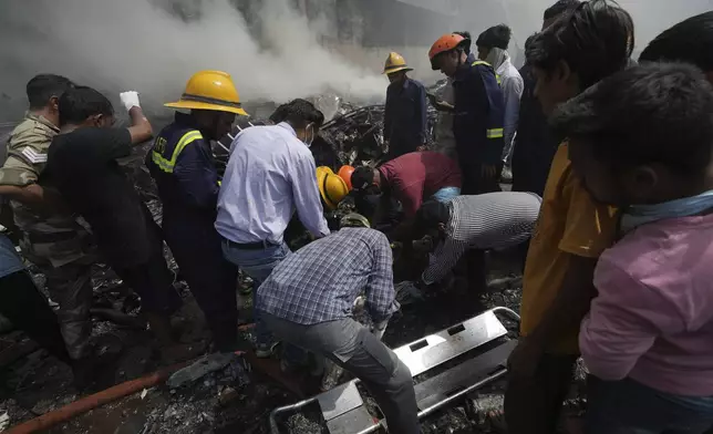 Rescuers work at the site of an airplane that crashed in India's northwestern city of Ahmedabad in Gujarat state, Thursday, June 12, 2025. (AP Photo/Ajit Solanki)
