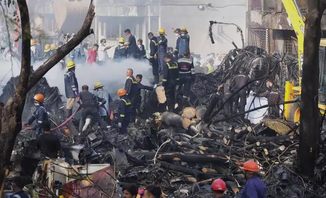 Search and rescue teams respond to the scene of a plane crash in Ahmedabad, India, Thursday, June 12, 2025. (AP Photo/Ajit Solanki)