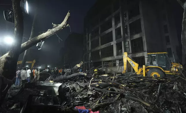Search and recovery teams work through the rubble of a plane crash in Ahmedabad, India, Thursday, June 12, 2025. (AP Photo/Ajit Solanki)