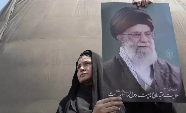 An Iranian protester holds up a poster of the Supreme Leader Ayatollah Ali Khamenei in an anti-Israeli gathering in Tehran, Iran, Friday, June 13, 2025. (AP Photo/Vahid Salemi)