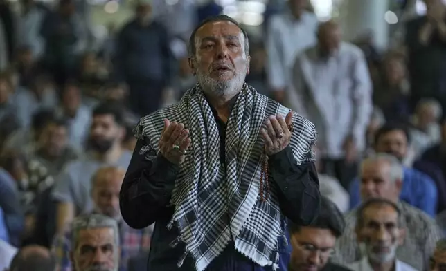 An Iranian worshipper prays as he attends Friday prayers ceremony at Tehran University campus in Tehran, Iran, Friday, June 13, 2025. (AP Photo/Vahid Salemi)