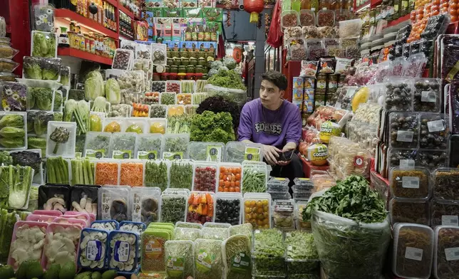 A shopkeeper waits for customers at Tajrish traditional bazaar in northern Tehran, Iran, Friday, June 13, 2025. (AP Photo/Vahid Salemi)