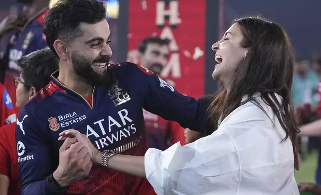 Royal Challengers Bengaluru's Virat Kohli shares a laugh with his wife Anushka Sharma after his team's win in the Indian Premier League final cricket match against Punjab Kings at Narendra Modi Stadium in Ahmedabad, India, Wednesday, June 4, 2025. (AP Photo/Ajit Solanki)