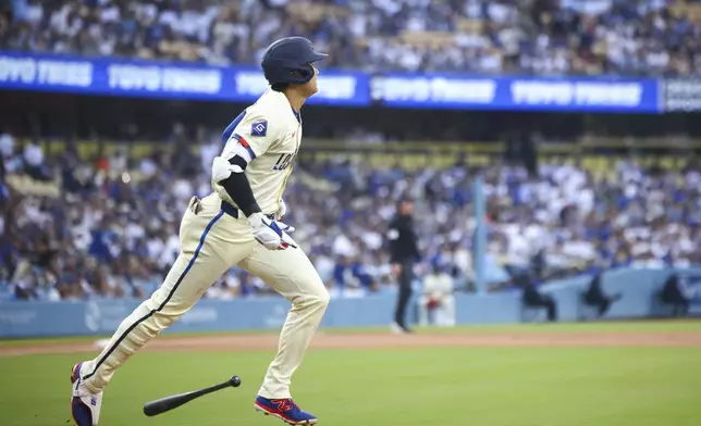 Los Angeles Dodgers designated hitter Shohei Ohtani drops his bat after hitting a home run during the first inning of a baseball game against the San Francisco Giants in Los Angeles, Saturday, June 14, 2025. (AP Photo/Jessie Alcheh)