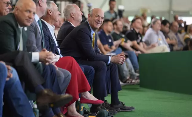 Athletics owner John Fisher, center, listens during a groundbreaking ceremony for the Athletics' baseball stadium Monday, June 23, 2025, in Las Vegas. (AP Photo/John Locher)