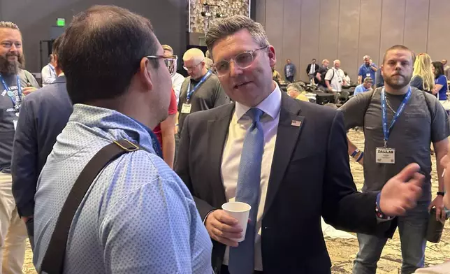 Brent Leatherwood, president of the Ethics and Religious Liberty Commission, greets a well-wisher after a commission-sponsored lunch at the annual meeting of the Southern Baptist Convention at the Kay Bailey Hutchison Convention Center in Dallas, Texas, Tuesday, June 10, 2025. (AP Photo/Peter Smith)