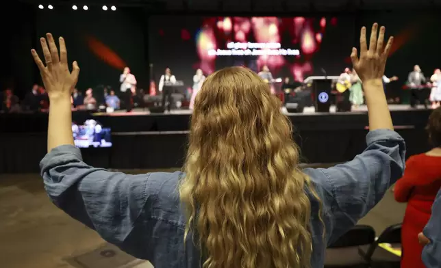 A messenger attending the Southern Baptist Convention participates in worship during the 2025 SBC Annual Meeting, Tuesday, June 10, 2025, in Dallas. (AP Photo/Richard W. Rodriguez)