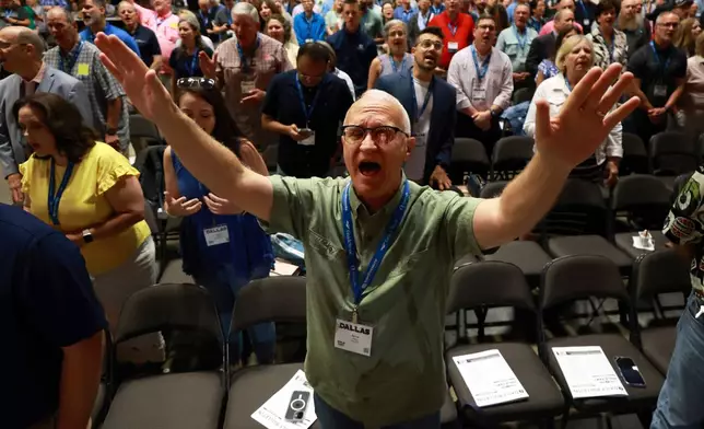 David Jenkins of Arlington, Texas, raises his arms during a worship session at the 2025 Southern Baptist Convention Annual Meeting, Tuesday, June 10, 2025, in Dallas. (AP Photo/Richard W. Rodriguez)