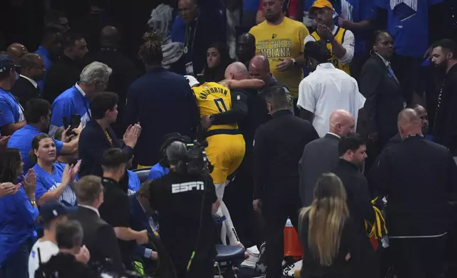 Indiana Pacers guard Tyrese Haliburton (0) leaves the court with an injury during the first half of Game 7 of the NBA Finals basketball series against the Oklahoma City Thunder Sunday, June 22, 2025, in Oklahoma City. (AP Photo/Nate Billings)