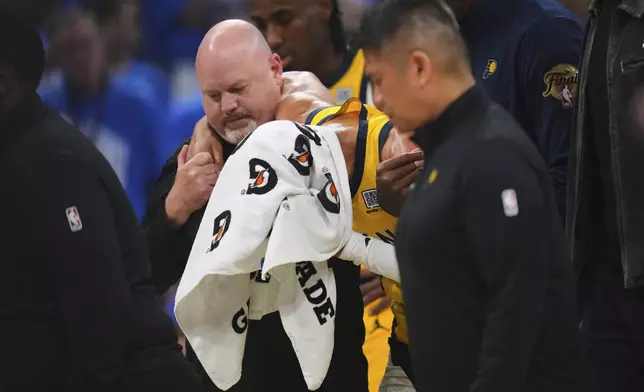 Indiana Pacers guard Tyrese Haliburton (0) leaves the court with an injury during the first half of Game 7 of the NBA Finals basketball series against the Oklahoma City Thunder Sunday, June 22, 2025, in Oklahoma City. (AP Photo/Julio Cortez)