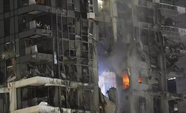 Fire and smoke rises from a destroyed building that was hit by a missile fired from Iran, in Tel Aviv, Israel on Friday, June 13, 2025. (AP Photo/Tomer Appelbaum)