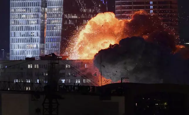 An explosion is seen during a missile attack in Tel Aviv, Israel, Friday, June 13, 2025. (AP Photo/Tomer Neuberg)