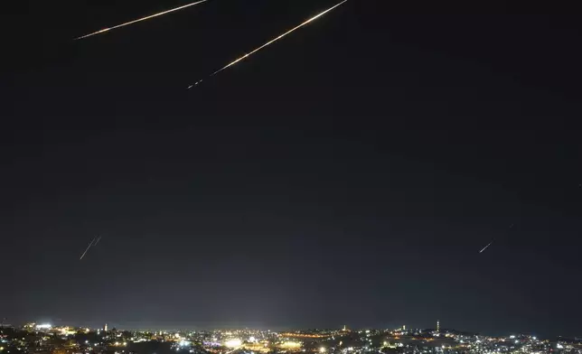 Traces are seen over Jerusalem during a missile attack alert, Friday, June 13, 2025. (AP Photo/Ohad Zwigenberg)